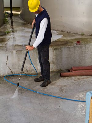 electrician and general worker washing the industrial site in a wine company